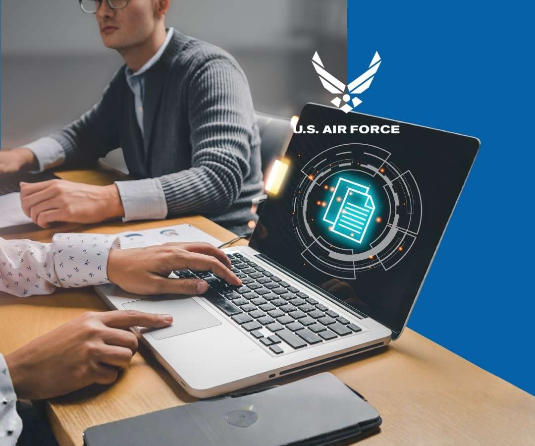 This portfolio features an image of two professionals collaborating at a desk using a laptop with a futuristic digital interface and the U.S. Air Force logo, highlighting teamwork, secure data management, and modern tech-driven work.